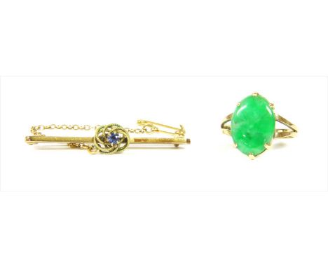 A 9ct gold jadeite ring, with an oval cabochon jadeite, six claw set to split shoulders and a flat section shank, London 1979