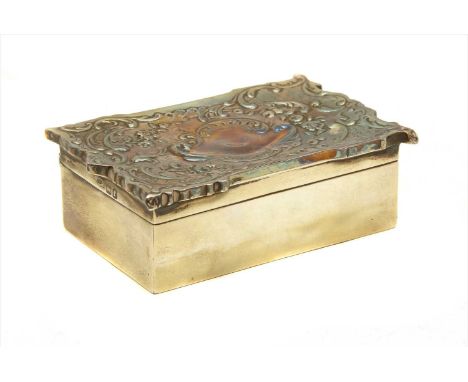 A silver trinket box, having profuse embossed foliate decorated lid, enclosing gilt interiors, London, 11cm wide, 7cm deep, 3