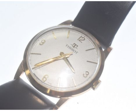 A vintage 9ct gold Tissot gent's wristwatch, with batons and Arabic numerals, on a leather strap. 