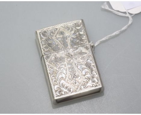 A silver Zippo style lighter, with engine turned decoration and stamped silver.