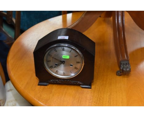 A 1930s oak cased mantel clock