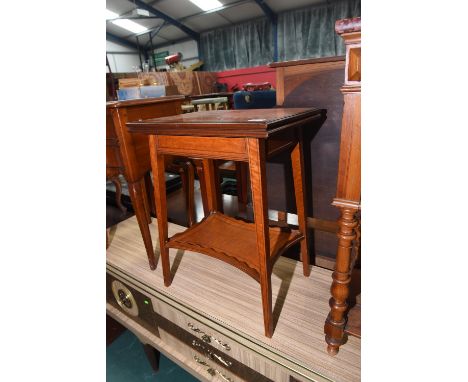 A Howard & Sons Edwardian painted satinwood foldover tea table with a shelf stretcher