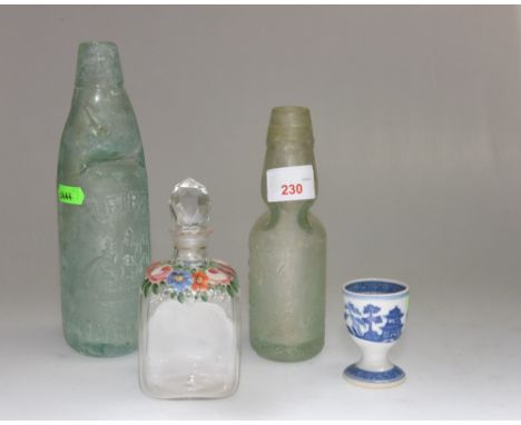 A group comprising: an enamel painted scent bottle, a pearl ware egg cup, two codd bottles (4) 
