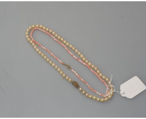 A cultured pearl necklace on a gold clasp, tog. with a small coral coloured bead necklace
