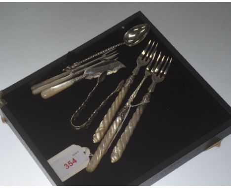 A group of silver flatware inluding pickle fork, butter knife, sugar tongs, etc, some with mother of pearl handles. 