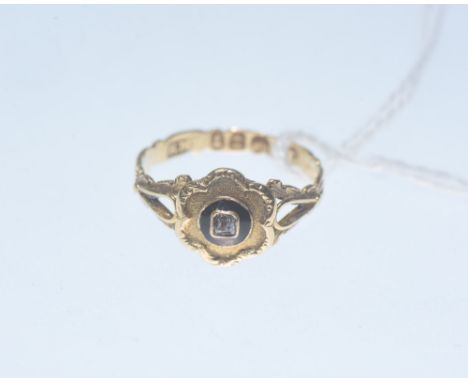 A George IV 18ct gold ring, set with a square cut colourless stone within an enamel band in a plaque setting on an engraved s