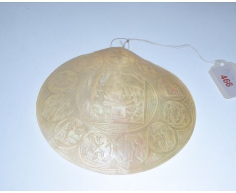 A carved mother of pearl shell decorated with the scenes from the Life of Christ centred by the Last Supper