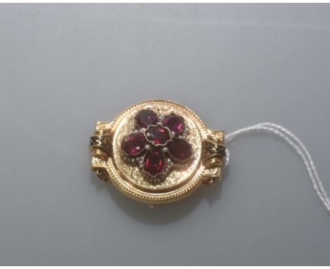 A Victorian pink tourmaline seed pearl and enamel brooch, in the Etruscan taste, mounted in yellow metal, with safety chain. 