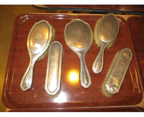 Four Silver Back Brushes and a Hand Mirror