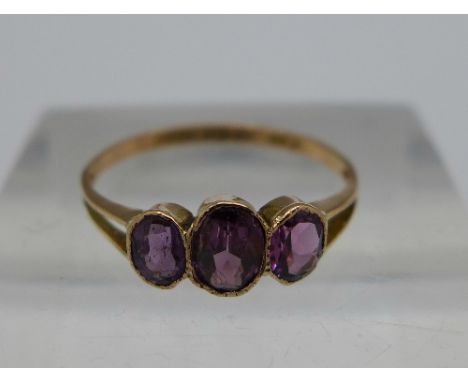 A 9ct gold three stone amethyst ring, Chester 1911, weight 0.8g, size K