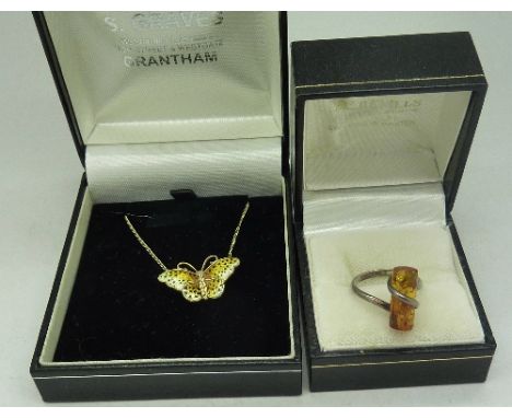 A silver and amber ring and a Norwegian silver and enamel butterfly pendant and chain