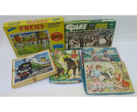 A Victory wood jigsaw puzzle of the Golden Arrow, a Giles jigsaw puzzle and four other jigsaw puzzles