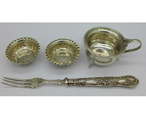 A pair of Victorian silver salts Birmingham 1897, a silver mustard lacking lid and a pickle fork with silver handle, weight o