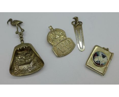 Four items of silver; a book mark, stamp case, an A.R.P. badge and a caddy spoon