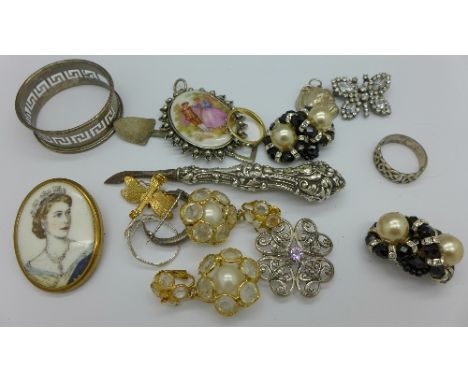 A Queen Elizabeth II portrait brooch, silver napkin ring, rings, earrings, etc.