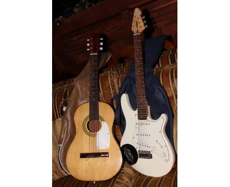 Vintage acoustic guitar and Peavey electric guitar.