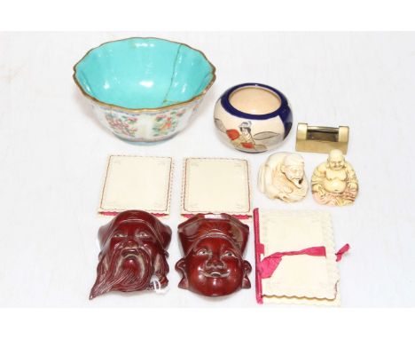 Small collection of Oriental items including famille rose bowl, two netsuke, masks, needle holders, etc.