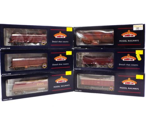Bachmann 00 gauge model railway rolling stock, two weathered EWS coal hoppers, 37-854, EWS weathered 102 tonne steel carrier,