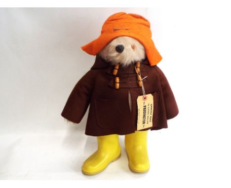 Paddington Bear, made in England, Gabrielle design, yellow boots (Dunlop Wellingtons) and hat, brown duffle coat   height app