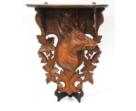 A Late XIX Century Black Forest Carved Wood Wall Bracket, in the form of a stag amongst foliage, 38cm high.Top with chips to 