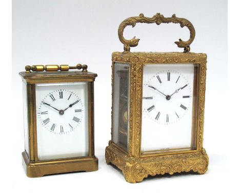 A French Early XX Century Brass Cased Carriage Clock, with elaborate floral embossed decoration and bird head handle, the whi