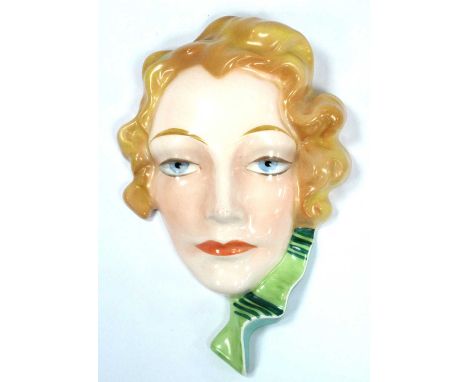An Art Deco Czechoslovakia Hand-Painted Wall Mask of a Lady, with blonde hair and green scarf, stamped 13449, 21.5cm long.