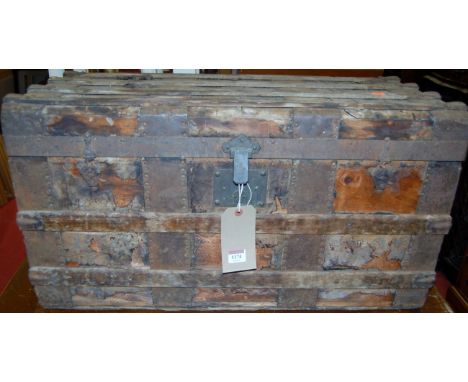 A circa 1900 pine part canvas clad and metal bound hinged top travelling trunk, having leather end carry handles (with signif