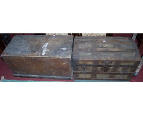 An early 20th century canvas clad wooden and metal bound domed hinge-top travelling trunk, having end carry handles; together