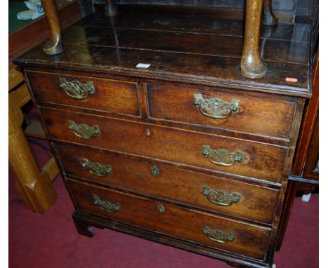 An early 19th century provincial oak squarefront chest of two short over three long graduated drawers, on bracket supports, w