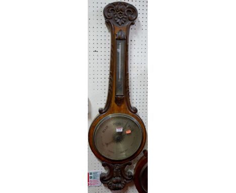 An early 20th century carved oak two-dial wheel barometer