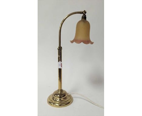 An adjustable brass table lamp, having a coloured glass shade, h.58cm 