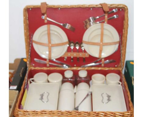 A mid 20th century picnic set, four place settings, comprising plates, flatware, flasks, containers, cups &amp; saucers, all 
