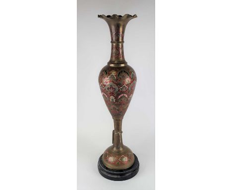 An Indian enamel decorated brass vase, having a frilled everted rim to slender neck and baluster body, on domed circular foot