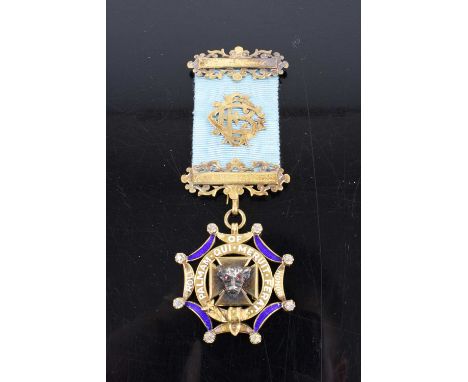 A silver gilt enamel and paste set Masonic jewel, with bar, by L Simpson &amp; Co of London, in original leather case