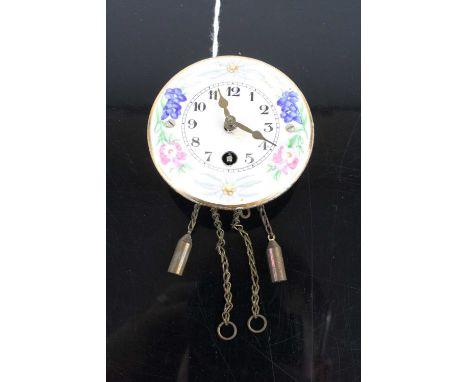 A Wintermantel pendulette miniature wall clock, having an enamel decorated circular dial (lacking pendulum), dia.6cm