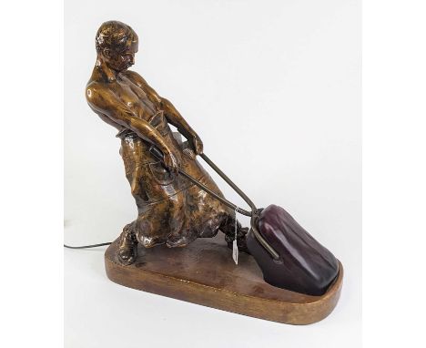After Richard W Lange, a bronzed table lamp in the form of a blacksmith, height 52cm