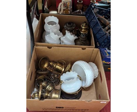 A collection of Victorian and later oil lamp parts, to include shades and burners 