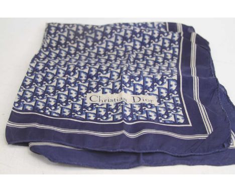 A blue and white silk scarf with geometric motif, bearing the name Christian Dior