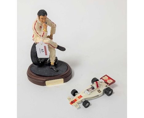 An Endurance The Art of Sports Series Graham Hill figurine, modelled seated on a tyre, on further wooden base with plaque, h.