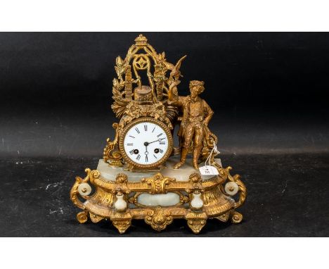 A French Gilt Metal Mantle Clock, white porcelain dial, Roman numerals, surmounted with a well with figure beside. Some damag