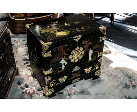 A Chinoiserie Decorated  black lacquered cabinet with gilt highlights and landscape decoration. Two doors to front with three