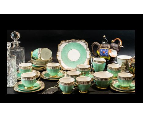 'Bell China' Fine Bone China Tea Service, comprising eleven cups, twelve saucers, twelve side plates, a bread and butter plat