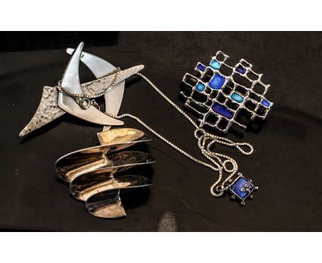 David Anderson Silver Brooch of abstract form with blue enamel panels, together with a white metal Moda stylised brooch and o