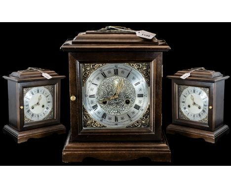 A Smith's Mantle Clock, silvered chapter dial with Roman numerals, oak effect case with carrying handle.  Good working order,