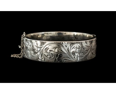 A Good Solid Silver Bangle, fully hallmarked for 925 Silversmiths R J Crafts (RJC), Birmingham.  Floral decoration finely don