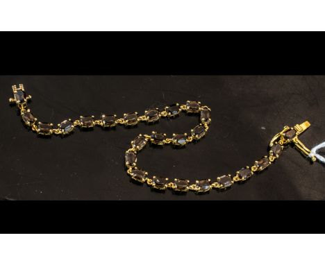 Smoky Quartz Tennis Bracelet, oval cut, warm, smoky quartz, totalling 8.5cts, gently sparkling in the light, set in a single 