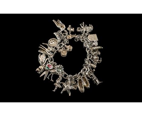 Vintage Sterling Silver Charm Bracelet - Loaded with 28 Silver Charms of Good Quality. All Marked for Sterling Silver. Compri