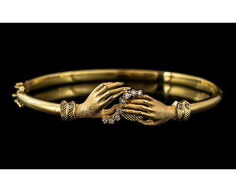 18ct Gold Diamond Set Hinged Bangle, the front formed as two hands set with 12 round cut diamonds. 750 continental hallmark. 