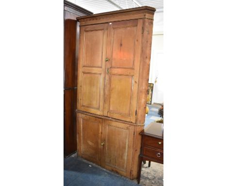 A 19th Century Pine Freestanding Two Tier Corner Cupboard having Moulded Cornice. the Top Section with Inverted Panelled Door