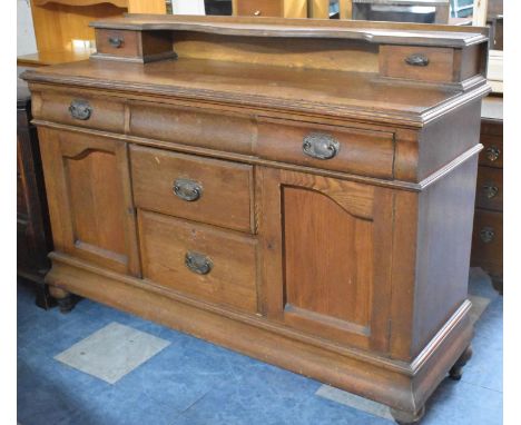 An Edwardian Oak Sideboard having Two Centre Drawers Flanked by Two Cupboards, Three Top Drawers, One Missing Handle, Galleri